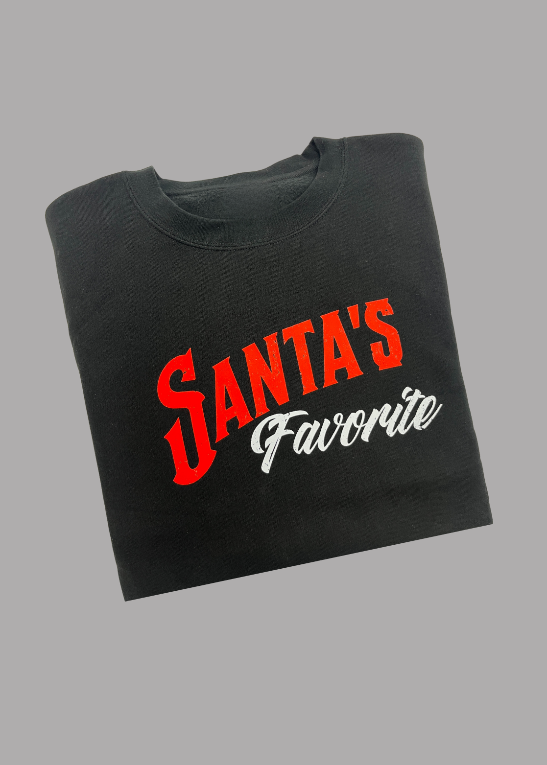 Black crewneck with 'Santa's Favorite' text in red and white on a gray background