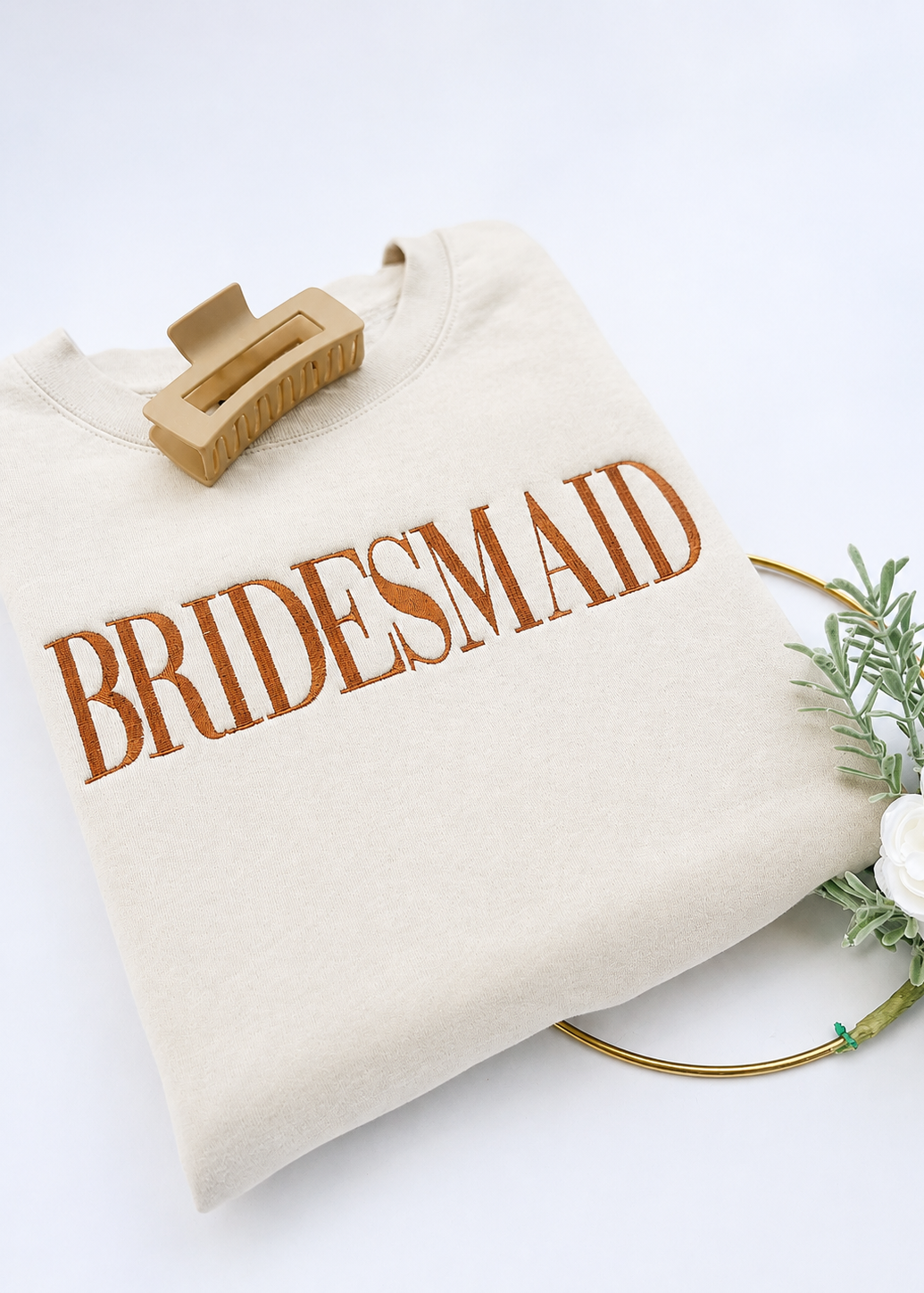 Beige tote bag with 'BRIDESMAID' text on a white background
