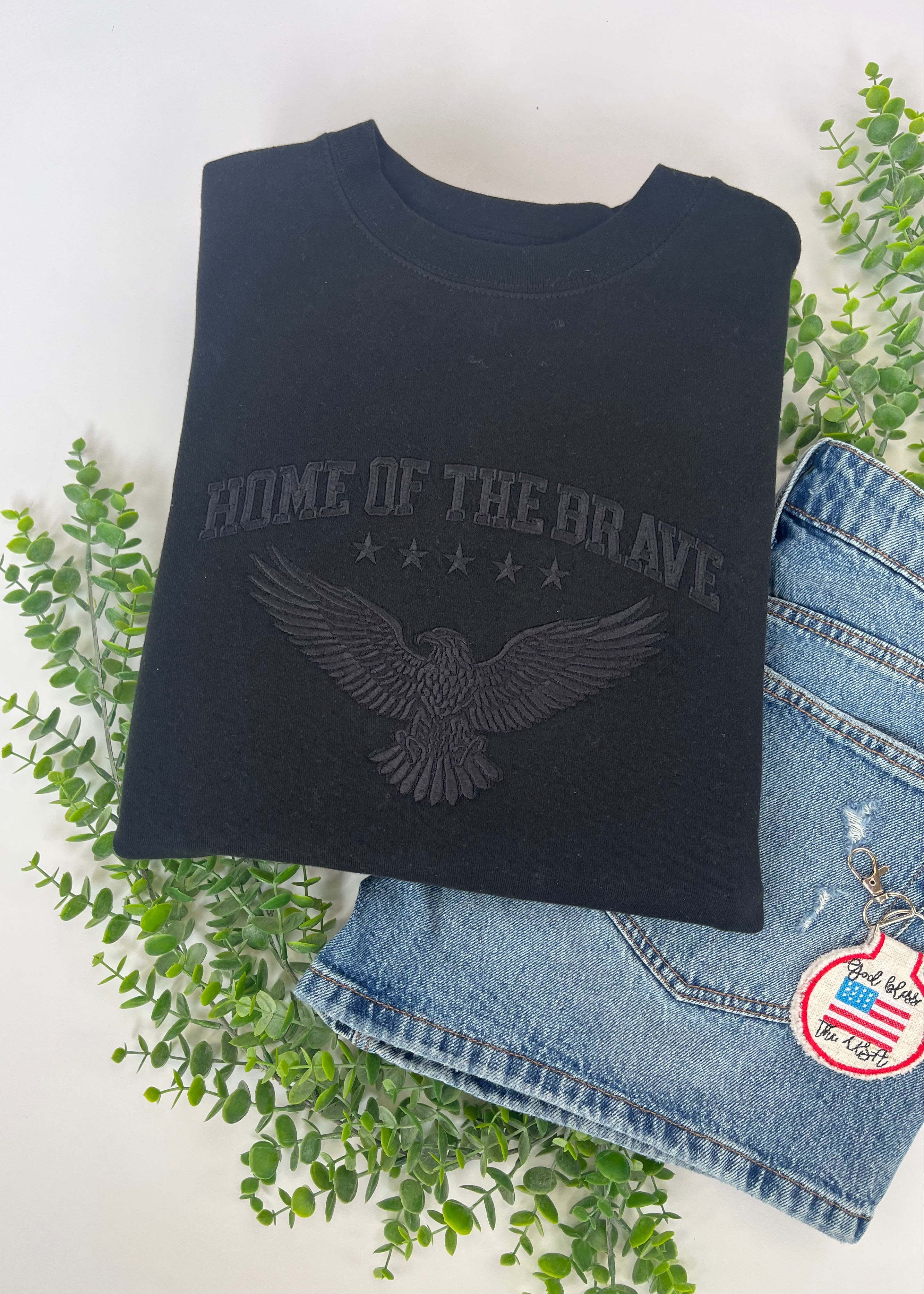black crewneck sweatshirt with black embroidery home of the brave and eagle