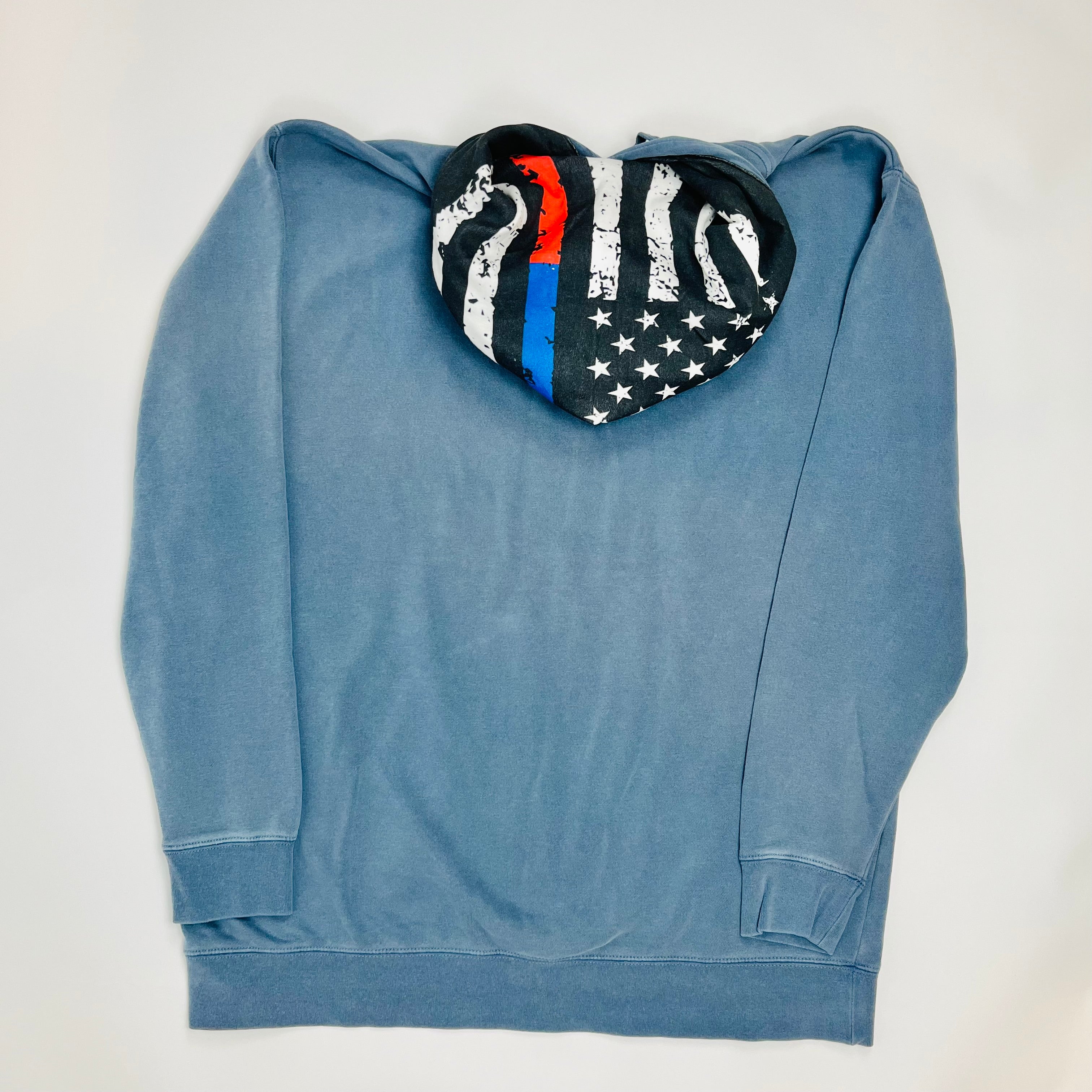 Blue hoodie with a heart-shaped American flag design on a white background. Line of Duty patriotic hoodie with blue and red flag design