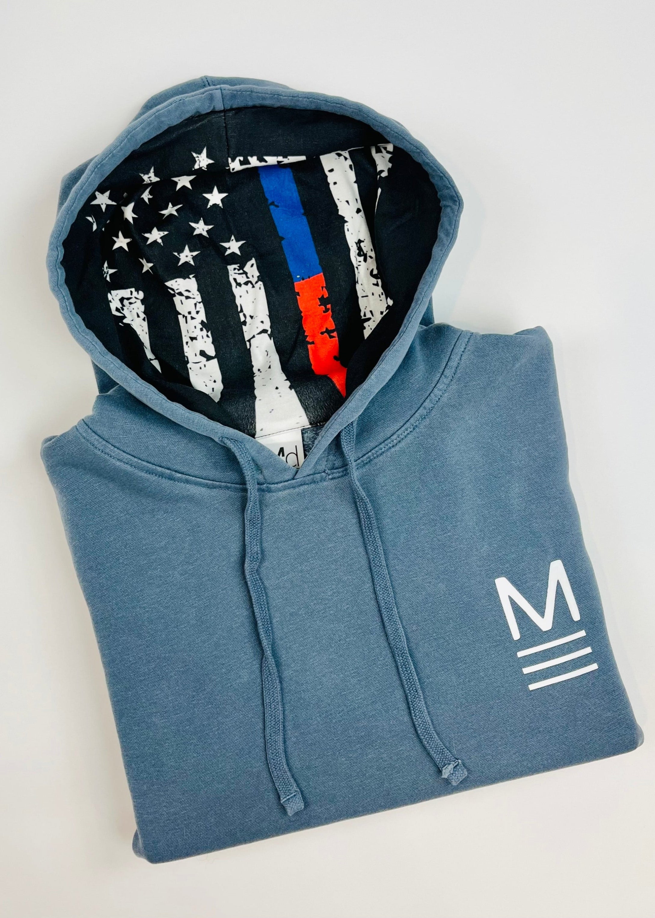 Blue hoodie with American flag design on the hood against a white background. Line of Duty patriotic hoodie with blue and red flag design