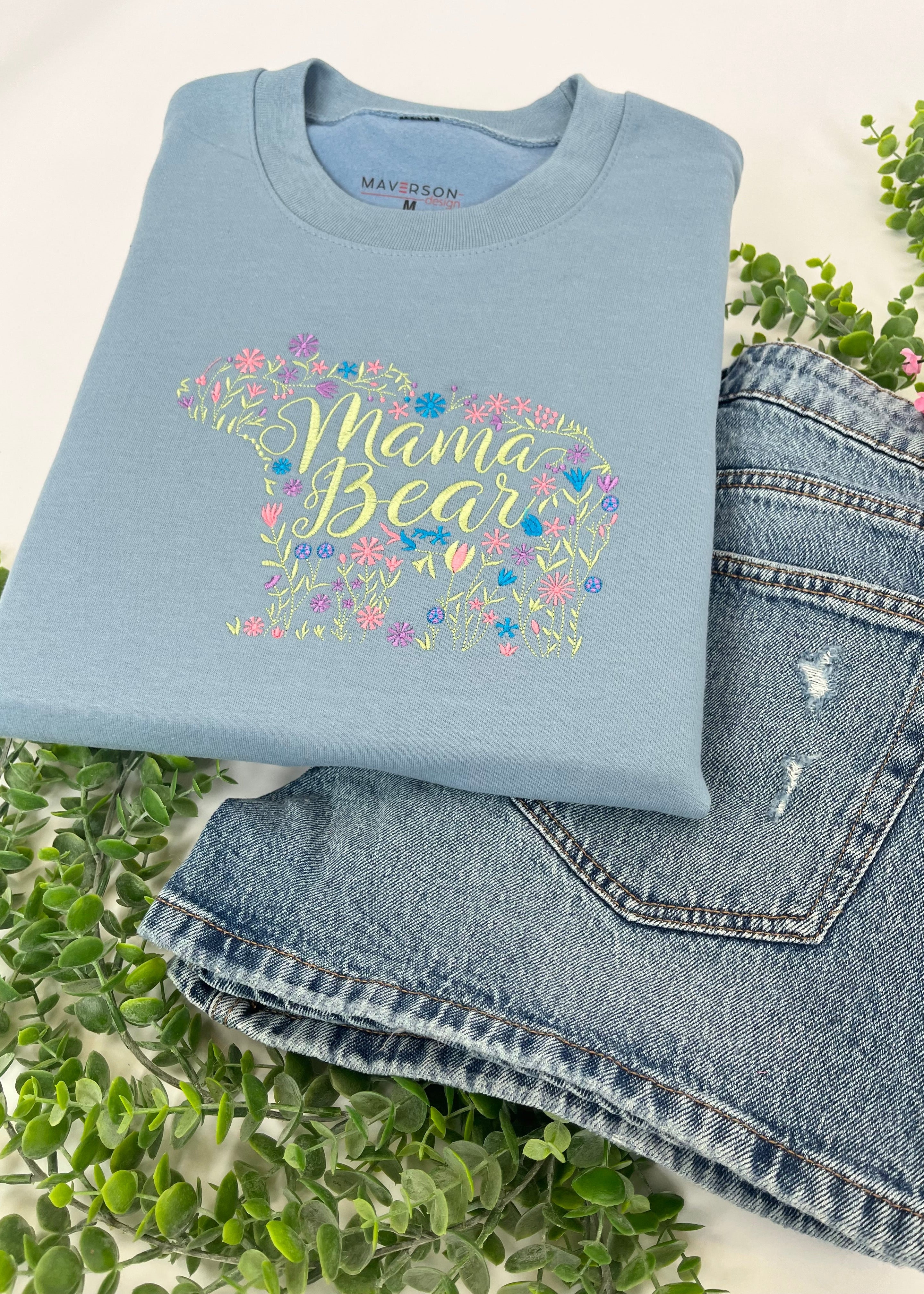 light blue crewneck sweatshirt with mama bear embroidery up close details