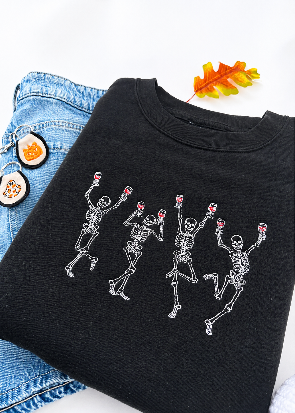 Black sweatshirt with dancing skeletons design on a white background
